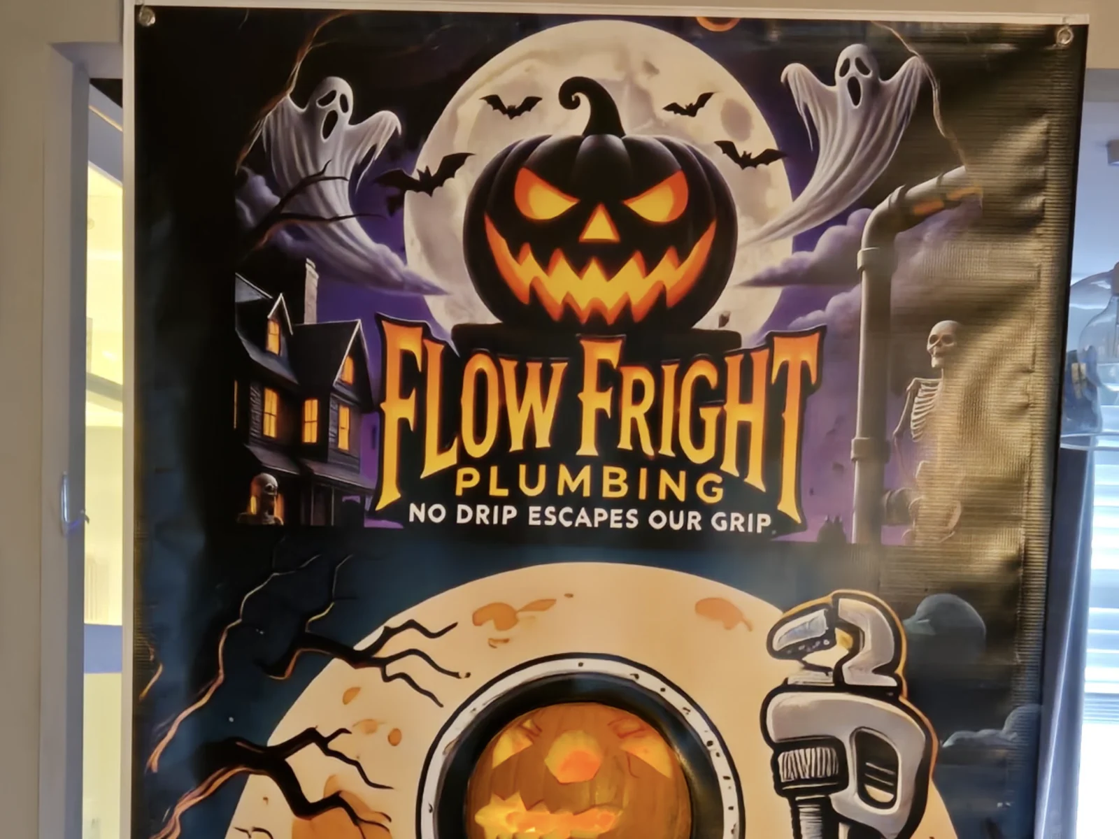 Flow Fright Plumbing Halloween display banner with a pumpkin, ghosts and a plumber's wrench