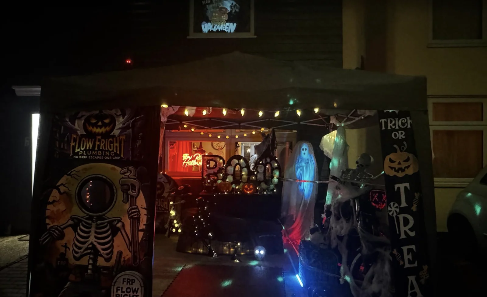 Front garden graveyard display outside 8 Osborne Road in Willesborough after dark